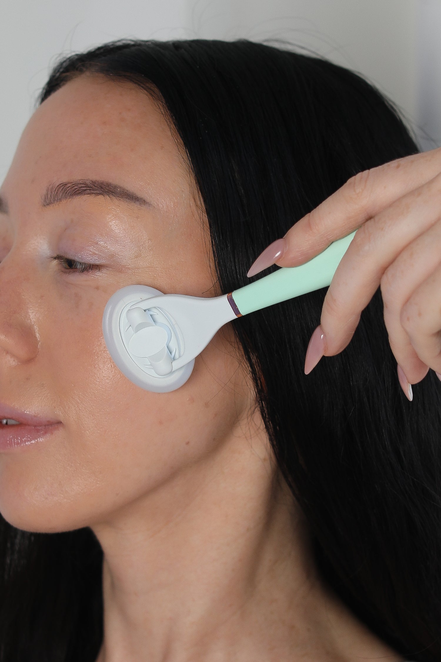 woman applying skincare with LUNAESCENT applicator